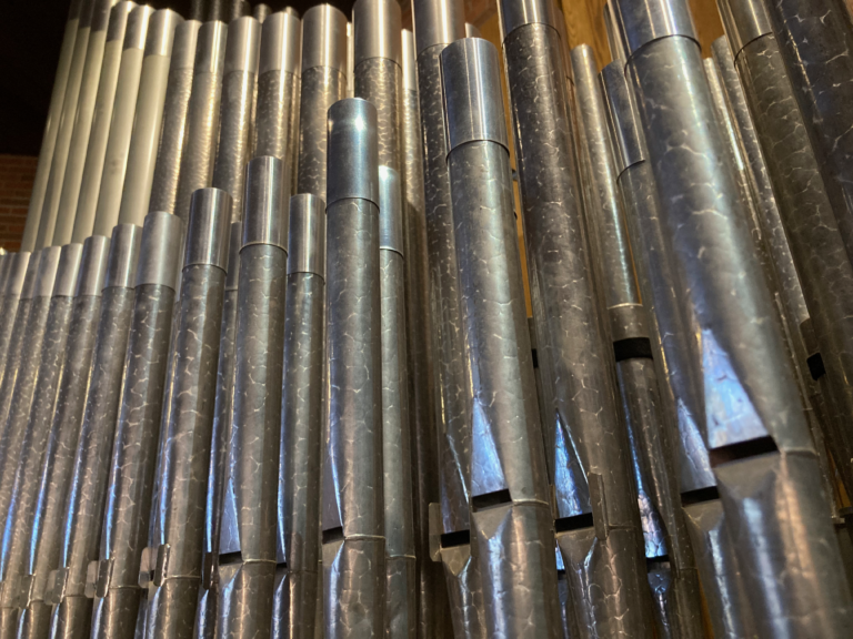 A closeup photo of pipes in a church organ.